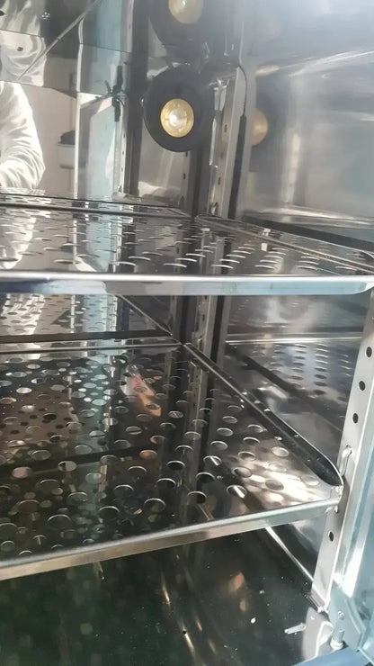 Stainless steel thermo scientific heratherm igs60 incubator with perforated shelves and circular heating element interior