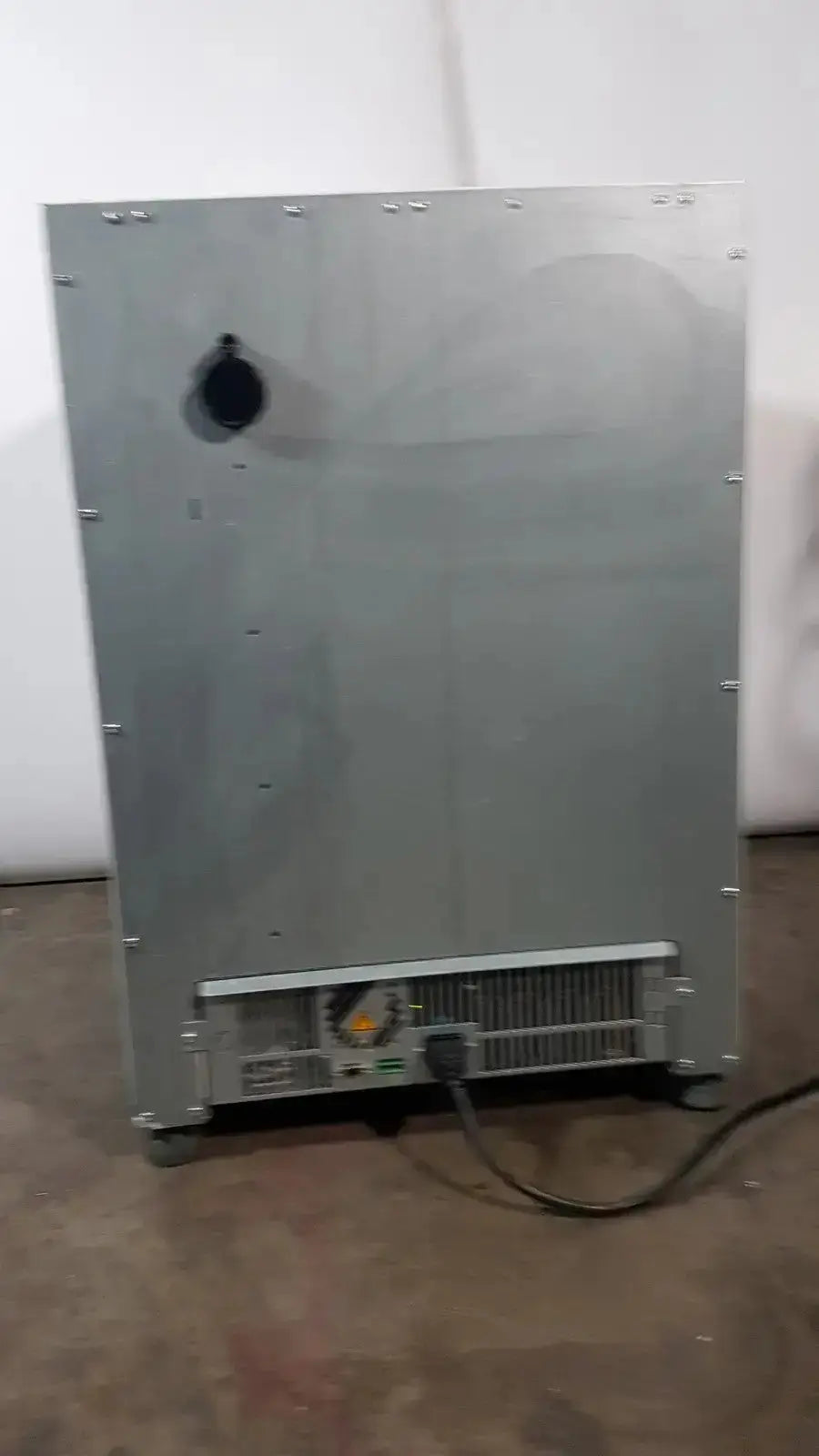 Silver metallic thermo scientific heratherm igs60 incubator with black circular vent and ventilation grille at the bottom