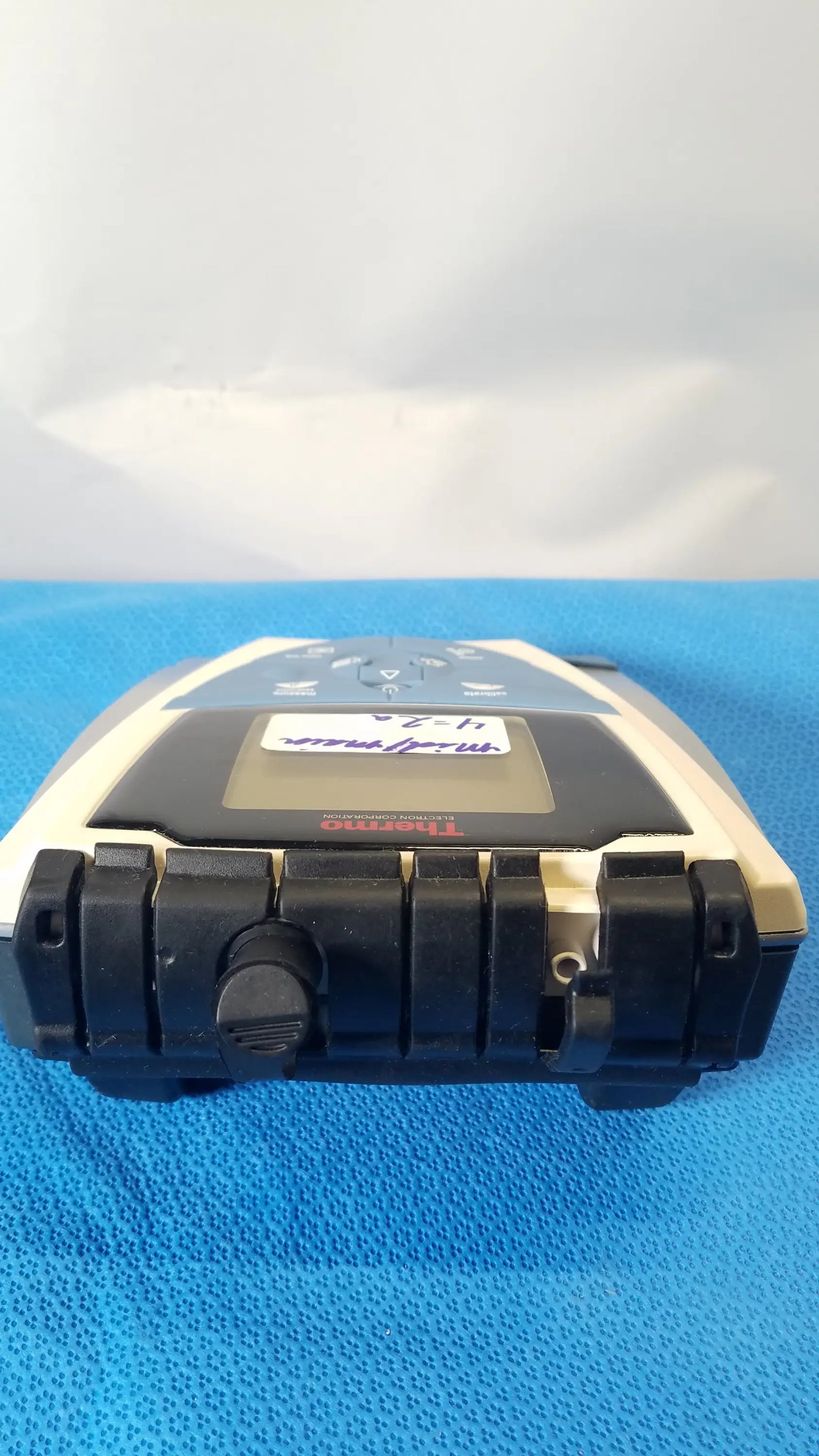Beige and black handheld Trimble surveying instrument with digital display rugged casing used with thermo scientific benchtop meter medical equipment