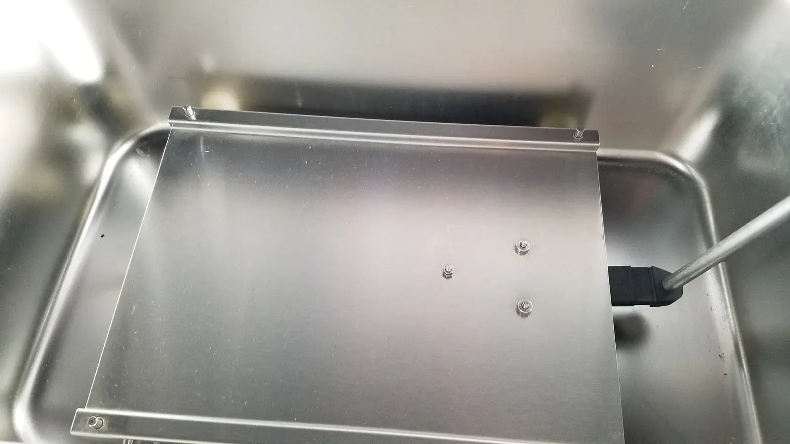 A sleek rectangular stainless steel tray with brushed finish and screws for thermo scientific swb25 digital shaker water bath medical equipment