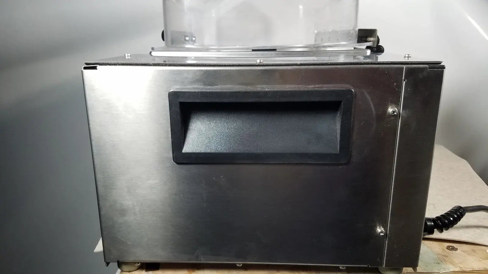 Stainless steel food vacuum sealer with clear plastic chamber and black rubberized handle used in medical equipment thermo scientific swb25