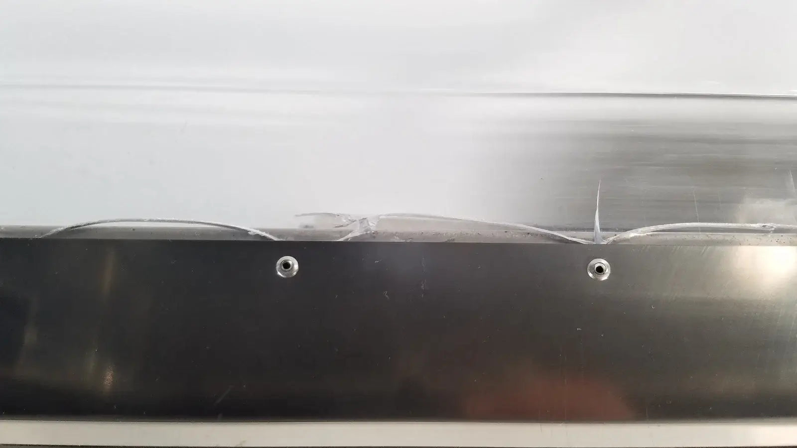 Black plastic container with two silver screws on the side of thermo scientific swb25 digital shaker water bath medical equipment