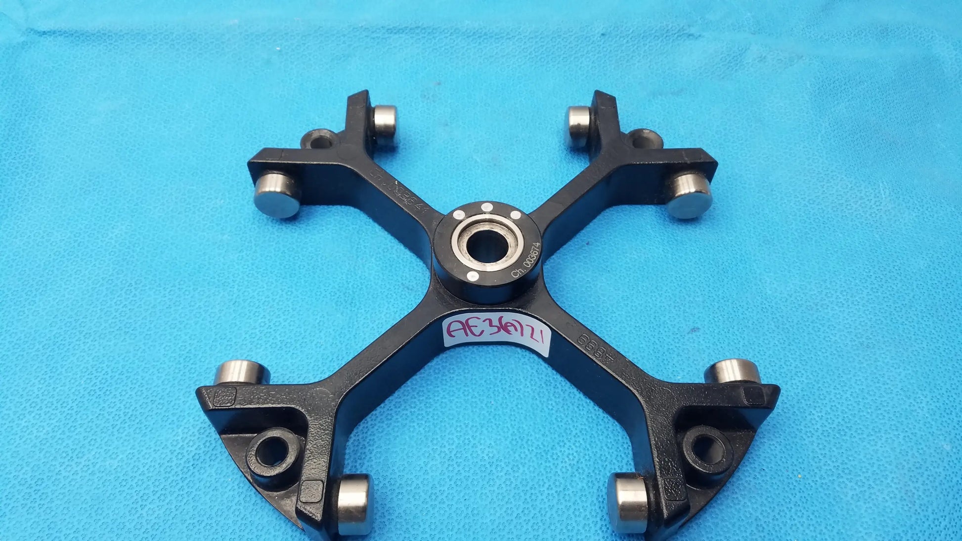 Black metal bicycle wheel hub with silver bearings and central bearing housing for reuse medical equipment use