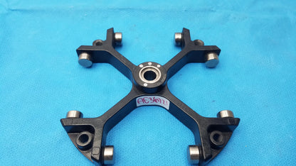 Black metal bicycle wheel hub with silver bearings and central bearing housing for reuse medical equipment use