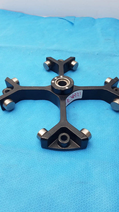 Black metal cross-shaped mechanical component with silver ball bearings for thermo sorvall 75006445 heraeus swing out rotor medical equipment reuse medical equipment