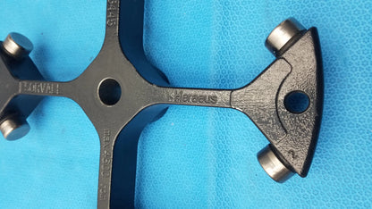 Black metal heraeus thermo sorvall 75006445 swing out rotor tool with four cylindrical ends and engraved markings for reuse medical equipment