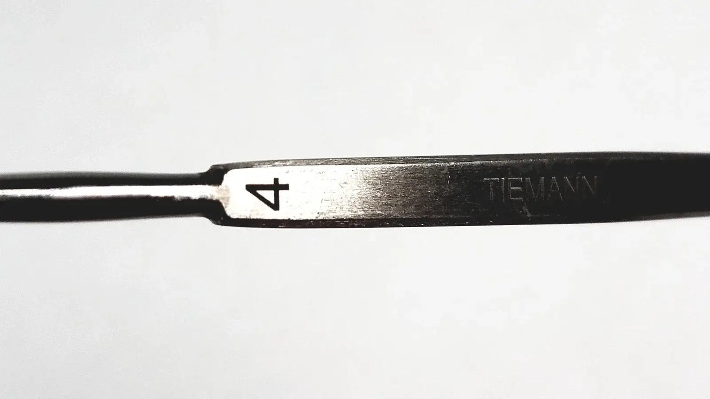 Black metal Tiemann surgical dermal curette size 4 with silver stainless steel cutting edge medical equipment