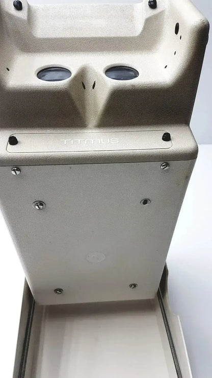 Titmus optical ii vision tester featuring a light gray textured metal bin with two circular openings for industrial use