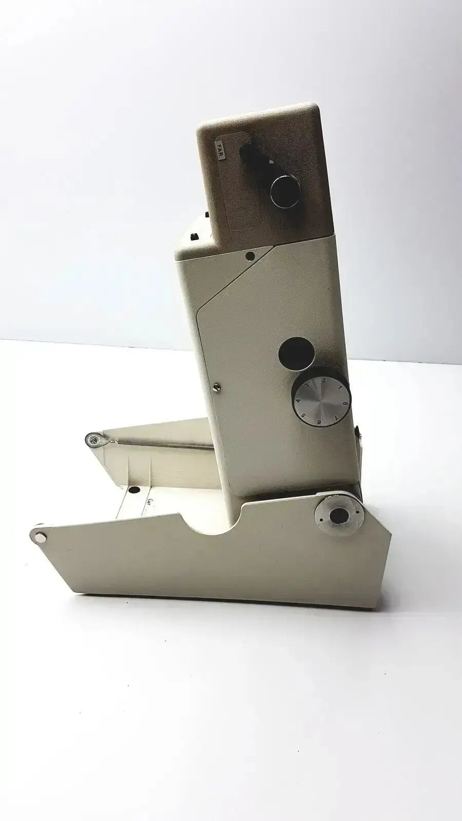 Beige metal microscope with black and silver knobs in titmus optical ii vision tester for precise optical ii vision testing