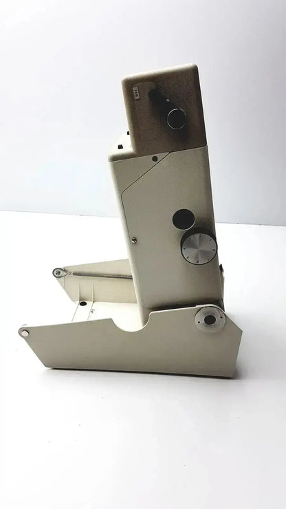 Beige metal microscope with black and silver knobs in titmus optical ii vision tester for precise optical ii vision testing