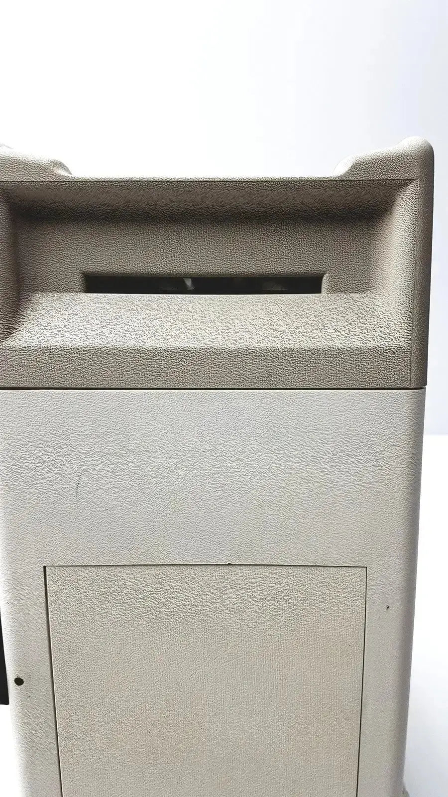 Beige textured outdoor trash can with rectangular slot and hinged door for titmus optical ii vision tester use