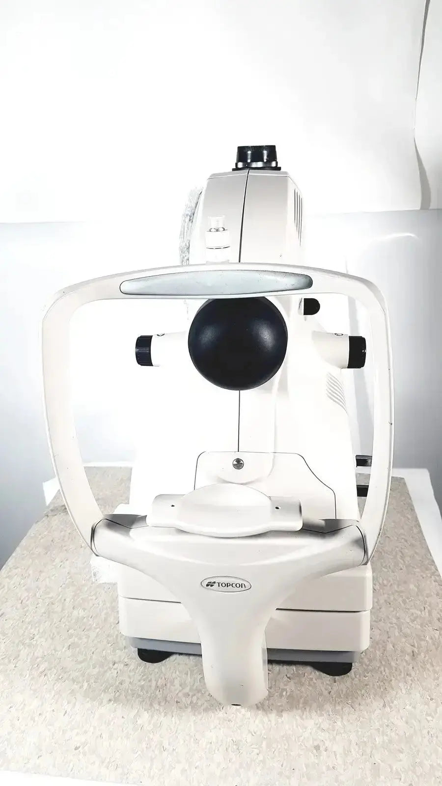White toricorn slit lamp biomicroscope with black circular lens and silver accents in topcon trc-nw8 retinal camera for sale