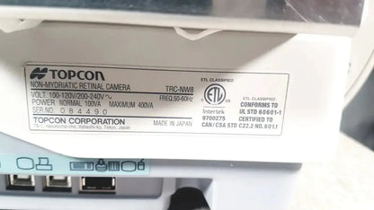 White plastic label with black text and logos for topcon trc-nw8 non mydriatic retinal camera used medical equipment for sale