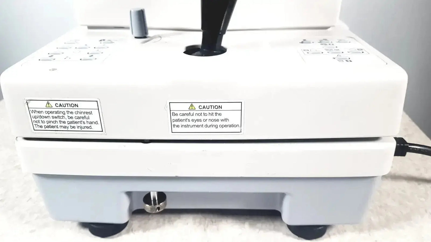White and light gray topcon trc-nw8 retinal camera with black control handle and caution labels used medical equipment for sale