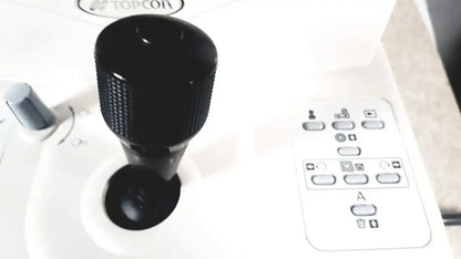 Black textured joystick with matte finish mounted on white control panel of topcon trc-nw8 retinal camera used medical equipment for sale