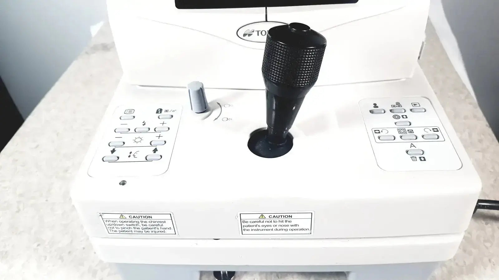 Black textured joystick with matte finish on white control panel of topcon trc-nw8 retinal camera used medical equipment for sale