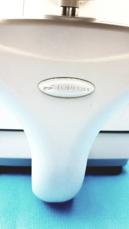 White plastic base of topcon trc-nw8 retinal camera with metallic logo plaque for digital fundus imaging system