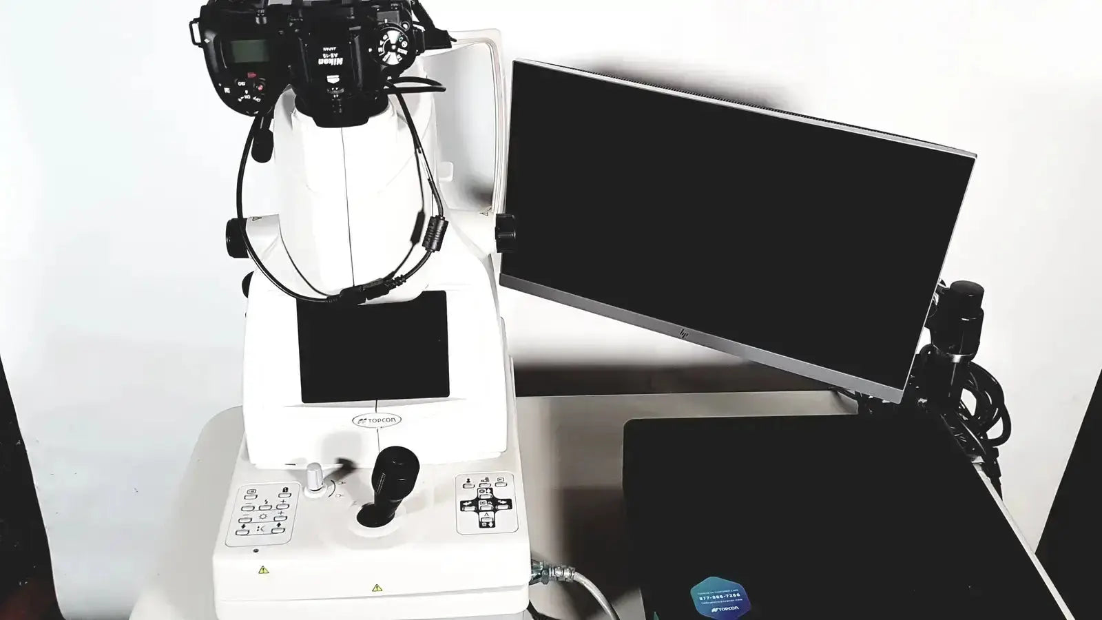 White clinical-grade Topcon TRC NW8 retinal camera with attached camera and control panel for eye examinations