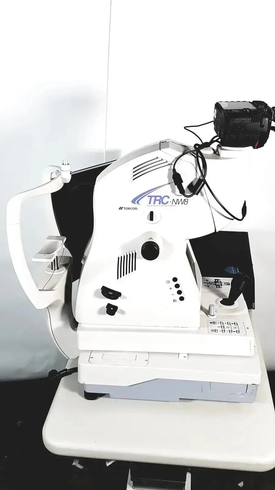 White Topcon TRC NW8 retinal camera slit lamp biomicroscope with black camera mounted for retinal imaging use