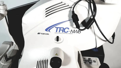 White Topcon TRC NW8 retinal camera with black cables and central control knob for precise retinal imaging use