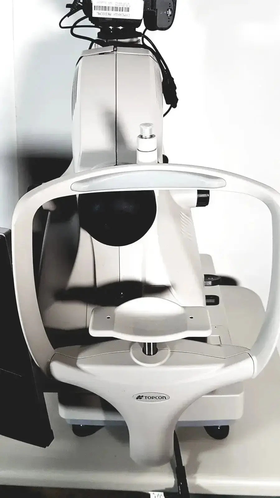 White topcon slit lamp biomicroscope with black accents featured in topcon trc nw8 retinal camera system