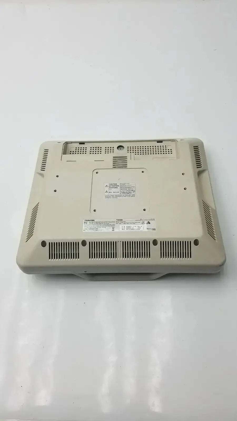 Beige plastic base with ventilation grilles and labels on the back of toshiba ta500 medical lcd monitor bsm31-7130