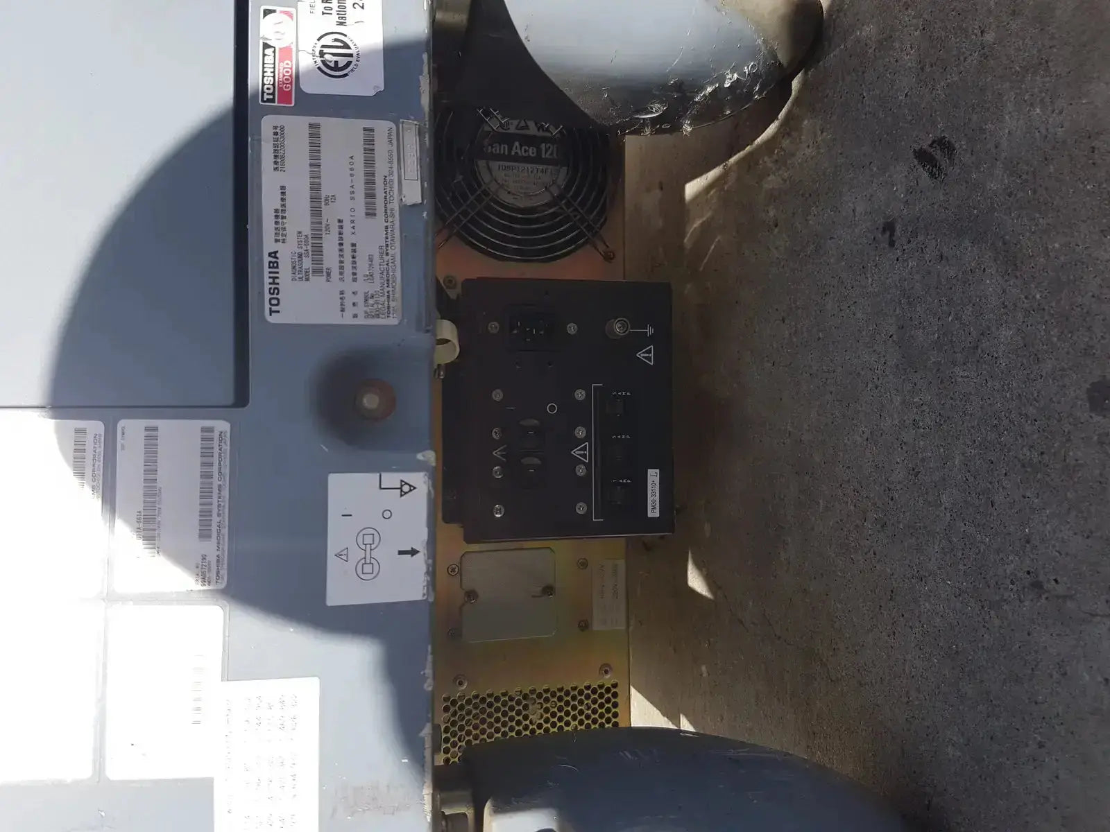 Black toshiba power supply unit with ventilation fan and control panel for diagnostic ultrasound machine back side