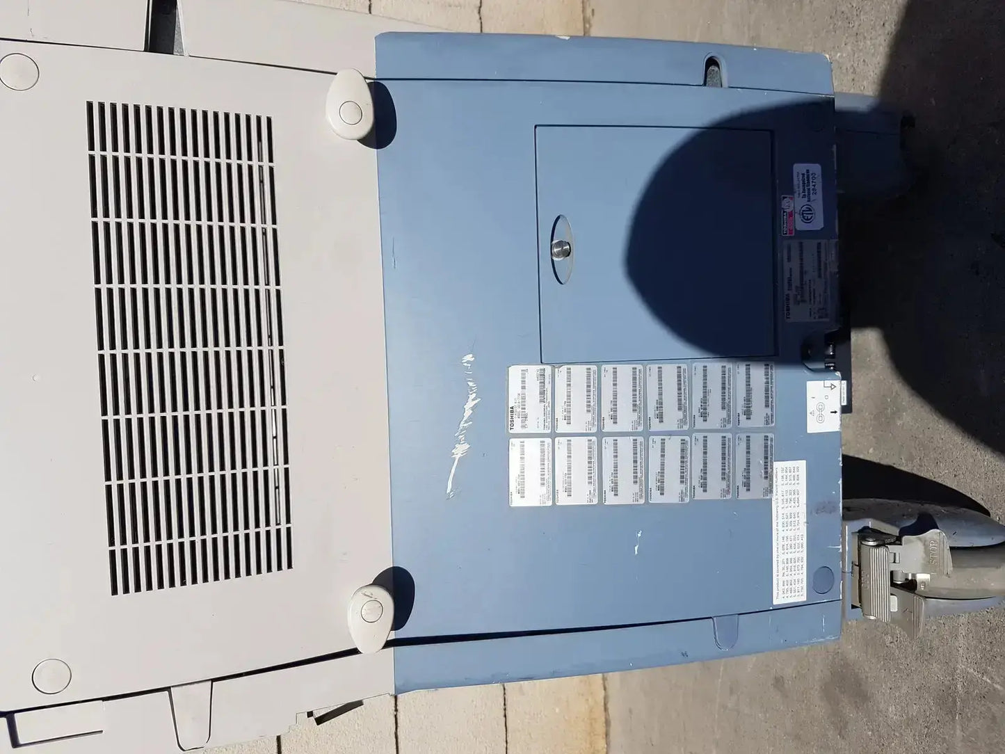 Blue and gray industrial electrical panel with vented side and keyhole on back of toshiba xario xg diagnostic ultrasound machine