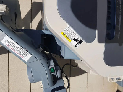 Gray and white motorized boat outboard engine with green power button featured on toshiba xario xg ssa-660a diagnostic ultrasound machine back side