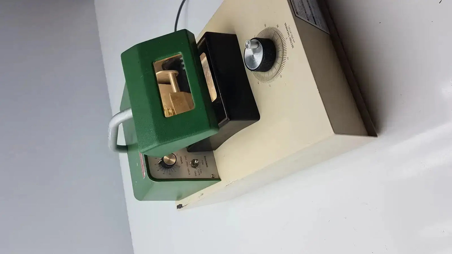 Green and black laboratory-grade uv lamp with metallic dial for intensity adjustment in tpi vibratome series 1000 sectioning system