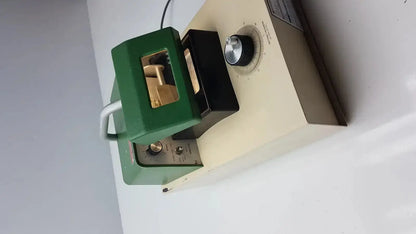 Green and black laboratory-grade uv lamp with metallic dial for intensity adjustment in tpi vibratome series 1000 sectioning system