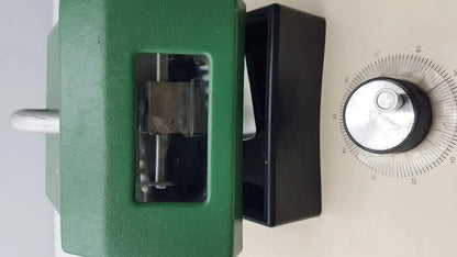 Green metal calibration device with black dial and silver knob on tpi vibratome series 1000 sectioning system