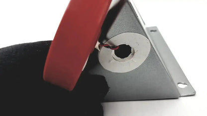 Red-handled pliers gripping wire near gray metal bracket hole on the back of tremetrics oscar electro-acoustic ear used medical equipment for sale
