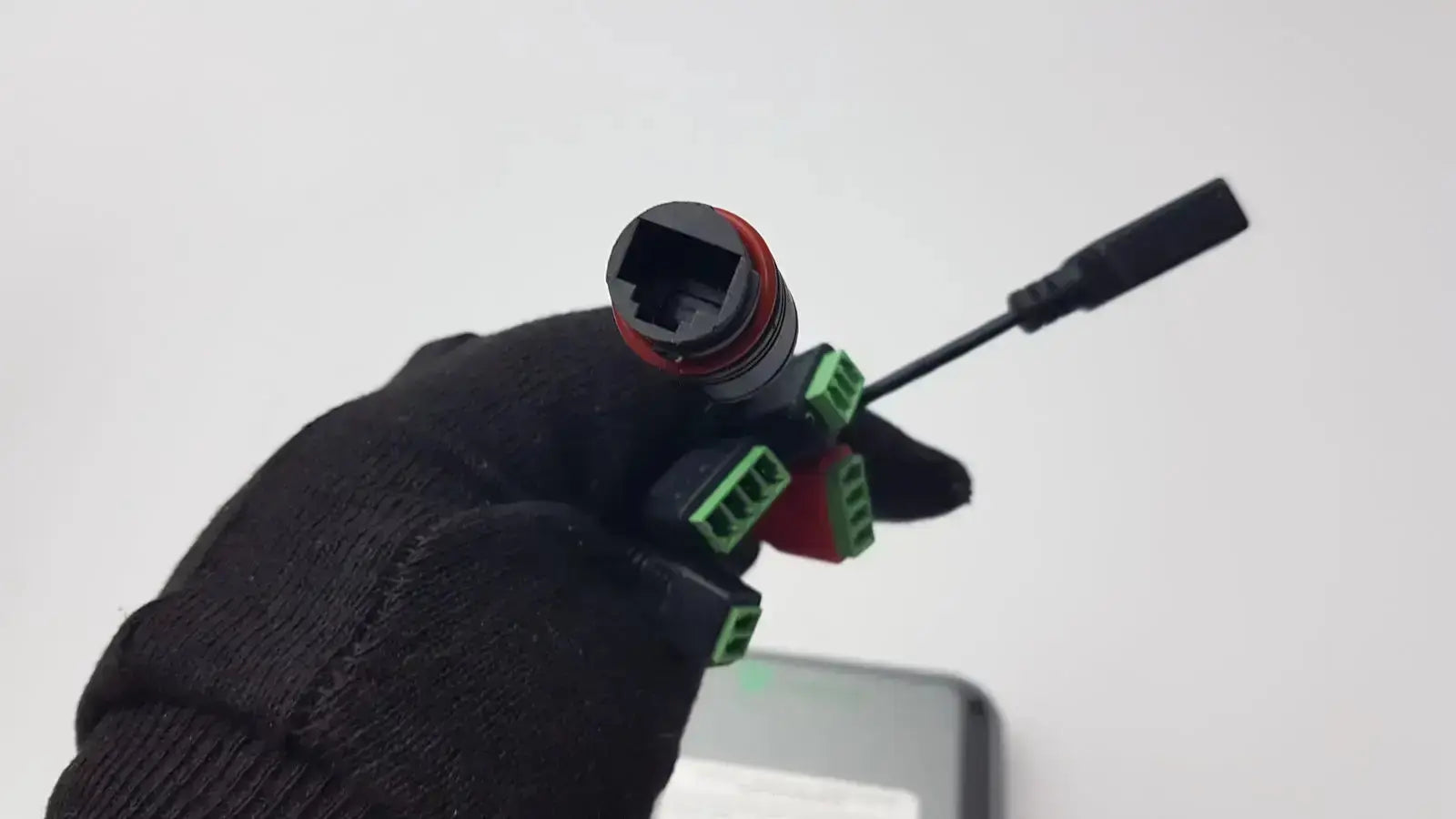 Back side of turing body temperature thermal scanner model tvts-op-btts 7-g2 showing black and red connector with green terminals