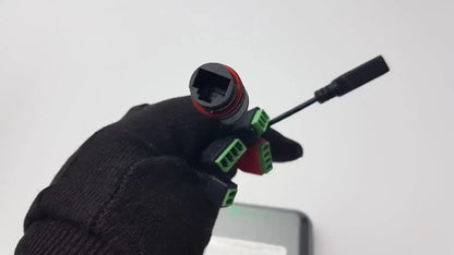 Back side of turing body temperature thermal scanner model tvts-op-btts 7-g2 showing black and red connector with green terminals