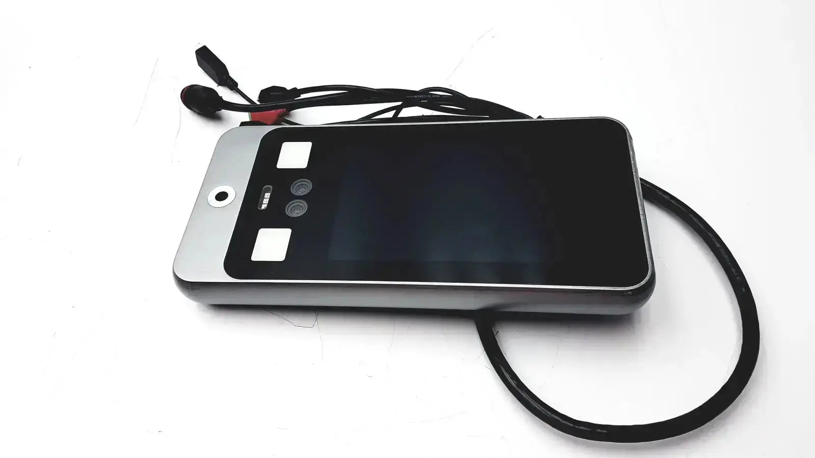Silver-framed smartphone with black screen and wired earphones resting on turing body temperature thermal scanner model tvts-op-btts 7-g2