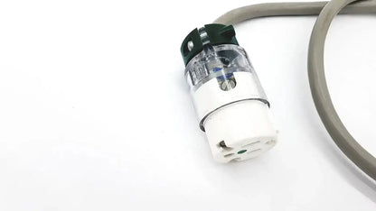 Clear plastic and white ul standard outdoor mini extension cord plug with green safety cap and three-pronged design
