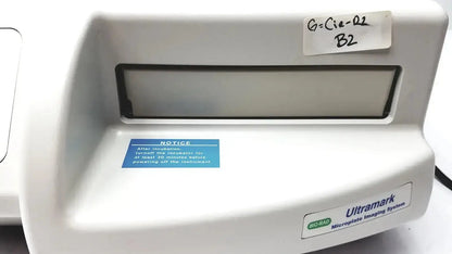 White plastic ultramark bio-rad microplate imaging system with rectangular window and labeled stickers for microplate imaging