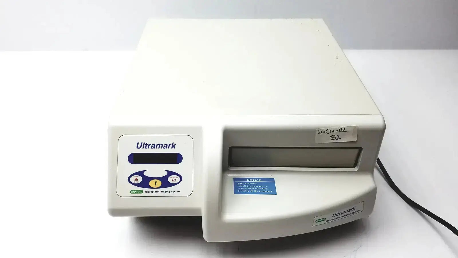 Off-white plastic Ultramark Bio-Rad microplate imaging system with control panel featuring blue and yellow buttons