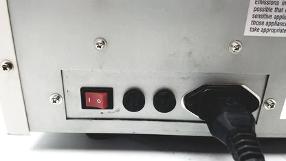 Black power cord plugged into the back of a silver ultramark bio-rad microplate imaging system with red on/off switch and ports