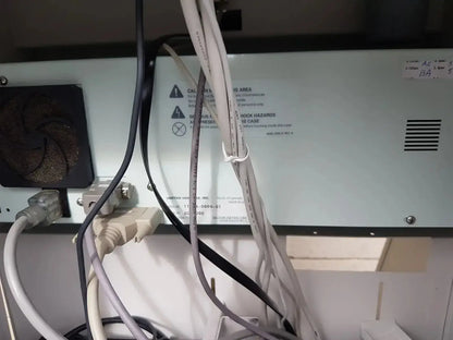 Backside view of Unetix series ii lhs vascular cart showing tangled white and black cables secured with a plastic clip