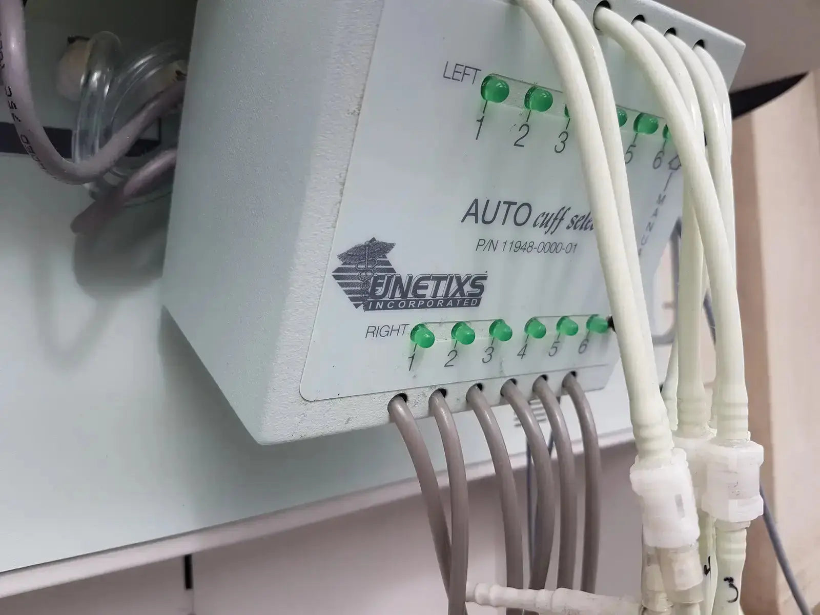 White plastic auto cuff sets with green indicator lights and cables on finetix multilab series ii lhs vascular cart