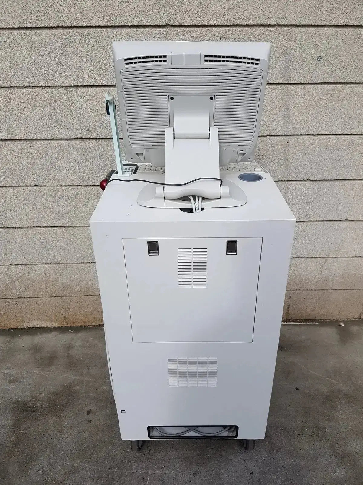 White all-in-one point-of-sale terminal with integrated monitor and cash drawer on Unetix multilab series ii lhs vascular cart