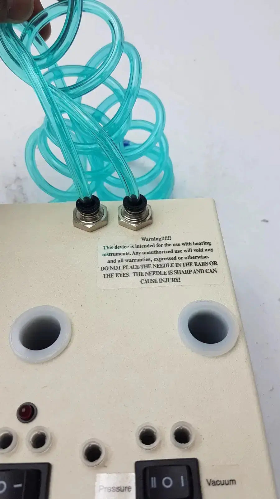 Beige unicorn medical md11684 desiccator vacuum system with turquoise coiled tubes and control buttons for pressure and vacuum