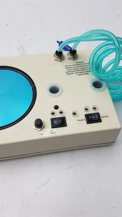 Beige unicorn medical md11684 desiccator vacuum system with blue window, black toggle switches, and turquoise coiled tubing