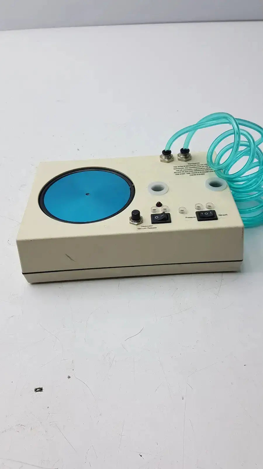 Beige rectangular unicorn medical md11684 desiccator vacuum system with blue panel black knobs and turquoise tubing