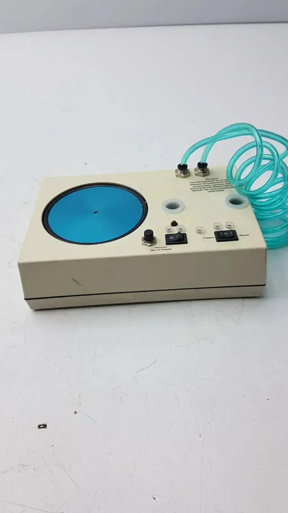 Beige rectangular unicorn medical md11684 desiccator vacuum system with blue panel black knobs and turquoise tubing