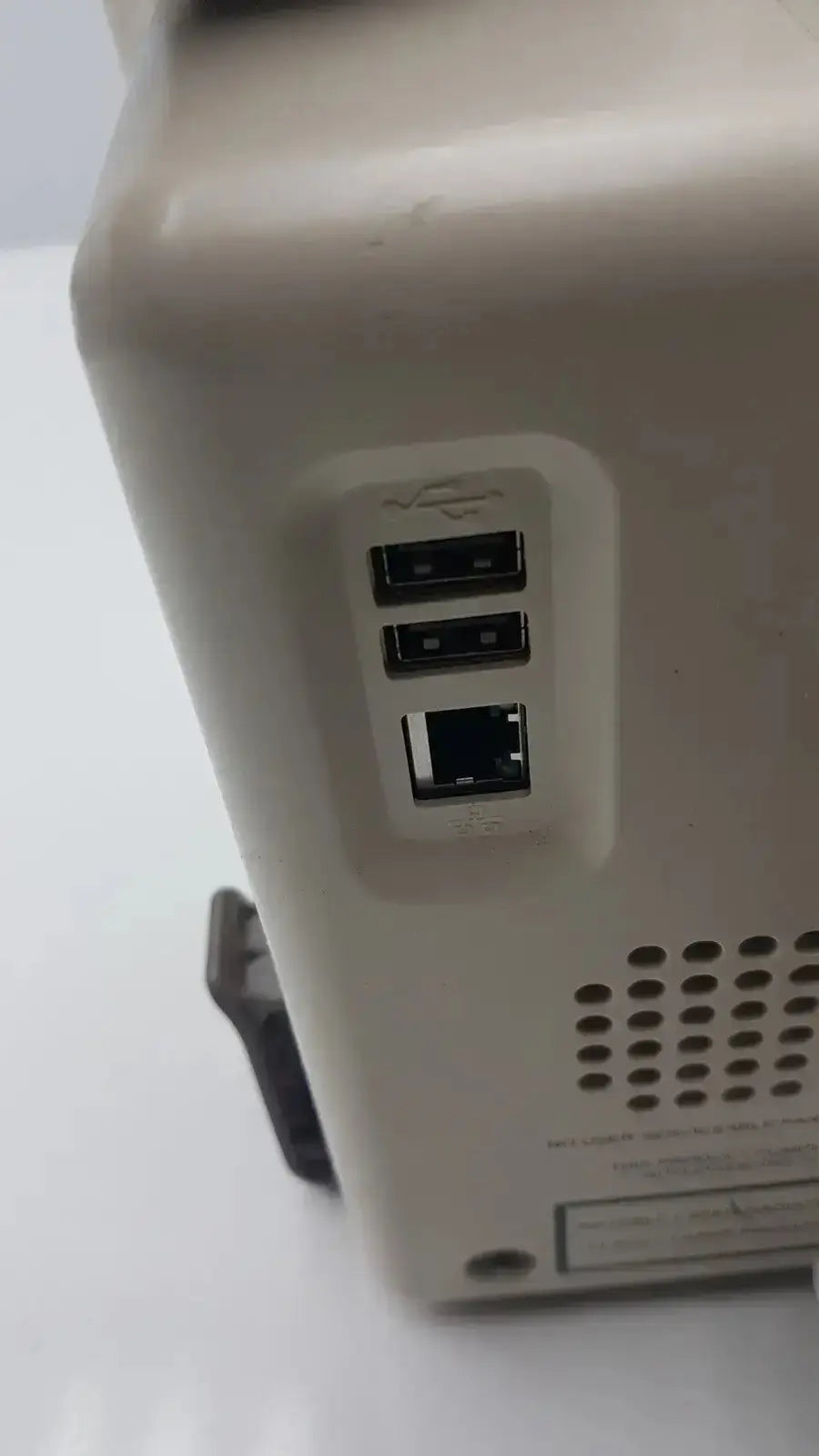 Beige plastic back side of Vasamed SensiLase pressure testing monitor with two usb ports and one ethernet port