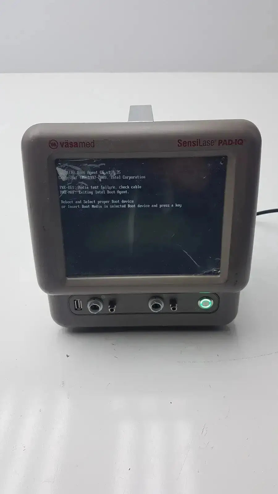 Gray plastic vasamed sensilase pressure testing monitor with cracked screen displaying diagnostic text pad-10