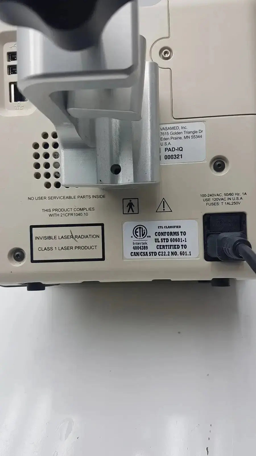 Beige plastic and metal vasmed sensilase pressure testing monitor with silver components and class 1 invisible laser label